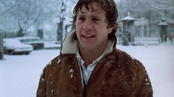Movie still from “Love Story” (1970), directed by Arthur Hiller – A man in a brown jacket standing in the snow; Close Up shot, Low angle