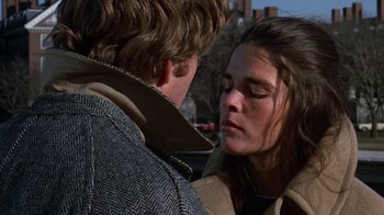Movie still from “Love Story” (1970), directed by Arthur Hiller – A man and a woman face to face in the street; Close Up shot, Over the shoulder angle