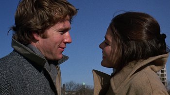 Movie still from “Love Story” (1970), directed by Arthur Hiller – A man and a woman face to face in front of a blue sky; Close Up shot, Over the shoulder angle