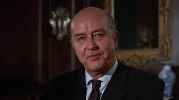Movie still from “Love Story” (1970), directed by Arthur Hiller – An older man wearing a suit and tie; Close Up shot, Low angle