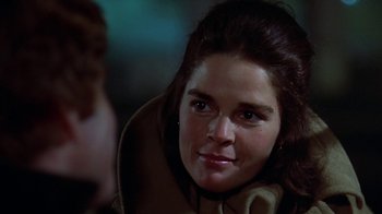 Movie still from “Love Story” (1970), directed by Arthur Hiller – A woman's face in the dark; Close Up shot, Over the shoulder angle