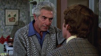 Movie still from “Love Story” (1970), directed by Arthur Hiller – An older man talking to a younger man in front of a mirror; Close Up shot, Over the shoulder angle