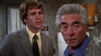 Movie still from “Love Story” (1970), directed by Arthur Hiller – A man and a woman standing next to each other in a room; Close Up shot, Over the shoulder angle