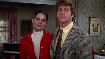 Movie still from “Love Story” (1970), directed by Arthur Hiller – A man and a woman standing next to each other; Close Up shot, Low angle