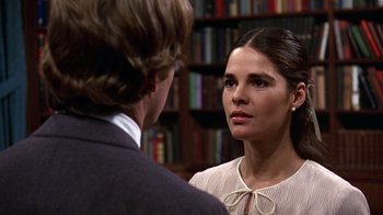 Movie still from “Love Story” (1970), directed by Arthur Hiller – A man and a woman talking in front of a book shelf; Close Up shot, Over the shoulder angle