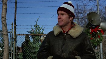 Movie still from “Love Story” (1970), directed by Arthur Hiller – A man wearing a leather jacket and a striped hat; Close Up shot, Low angle