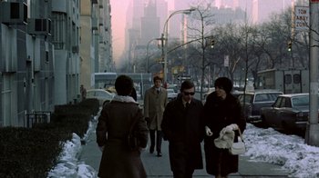 Movie still from “Love Story” (1970), directed by Arthur Hiller – A group of people walking down a sidewalk; Wide shot, Low angle