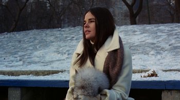 Movie still from “Love Story” (1970), directed by Arthur Hiller – A woman in a white coat holding an animal; Close Up shot, Low angle