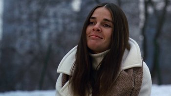 Movie still from “Love Story” (1970), directed by Arthur Hiller – A woman with long brown hair wearing a brown jacket; Close Up shot, Low angle
