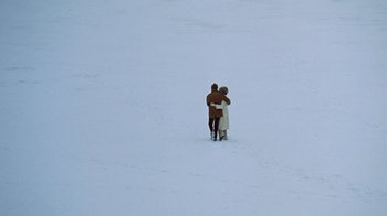 Movie still from “Love Story” (1970), directed by Arthur Hiller – A man and a woman hugging in the snow; Extreme Wide shot, High angle