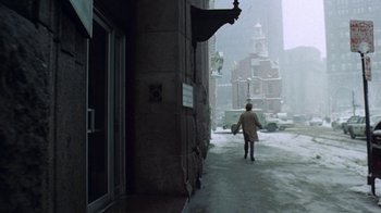 Movie still from “Love Story” (1970), directed by Arthur Hiller – A man walking down a street in the snow; Extreme Wide shot, High angle