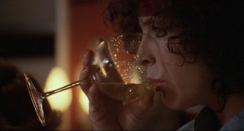 Movie still from “Love Streams” (1984), directed by John Cassavetes – A woman drinking a glass of wine with a straw; Close Up shot, Low angle