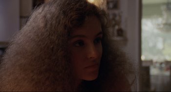 Movie still from “Love Streams” (1984), directed by John Cassavetes – A person with long curly hair; Close Up shot, Over the shoulder angle