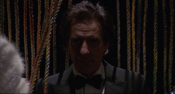 Movie still from “Love Streams” (1984), directed by John Cassavetes – A person wearing a suit and bow tie; Close Up shot, Low angle