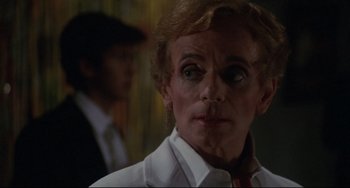 Movie still from “Love Streams” (1984), directed by John Cassavetes – A person wearing a white shirt; Close Up shot, Over the shoulder angle