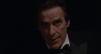 Movie still from “Love Streams” (1984), directed by John Cassavetes – A person wearing a suit and tie; Close Up shot, Low angle