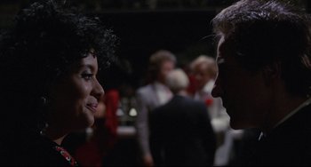 Movie still from “Love Streams” (1984), directed by John Cassavetes – A man and a woman talking to each other in front of a crowd; Close Up shot, Over the shoulder angle