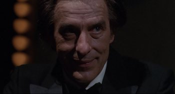 Movie still from “Love Streams” (1984), directed by John Cassavetes – A person wearing a suit and tie; Close Up shot, Low angle
