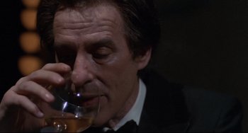 Movie still from “Love Streams” (1984), directed by John Cassavetes – A person holding a glass of wine; Close Up shot, Over the shoulder angle