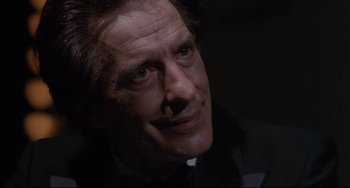 Movie still from “Love Streams” (1984), directed by John Cassavetes – A man's face in the dark; Close Up shot, Over the shoulder angle