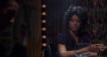 Movie still from “Love Streams” (1984), directed by John Cassavetes – A woman sitting in front of a mirror in a room; Medium shot, Over the shoulder angle