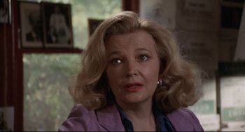 Movie still from “Love Streams” (1984), directed by John Cassavetes – A person with blonde hair wearing a purple jacket; Close Up shot, Over the shoulder angle