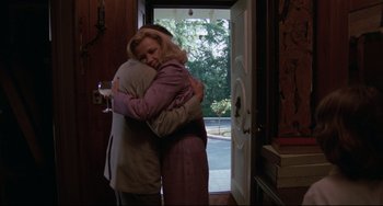 Movie still from “Love Streams” (1984), directed by John Cassavetes – Two people hugging in front of a door; Medium shot, Low angle
