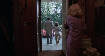 Movie still from “Love Streams” (1984), directed by John Cassavetes – A man and a woman walking out of a door; Wide shot, Over the shoulder angle