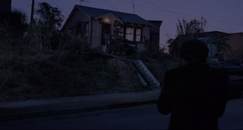 Movie still from “Love Streams” (1984), directed by John Cassavetes – A person walking down a street at night; Extreme Wide shot, Low angle