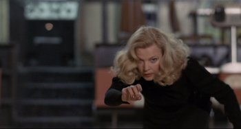 Movie still from “Love Streams” (1984), directed by John Cassavetes – A woman in a black shirt is pointing at the camera; Medium shot, Low angle