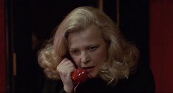Movie still from “Love Streams” (1984), directed by John Cassavetes – A woman holding a red phone up to her ear; Close Up shot, High angle