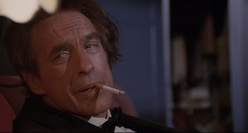 Movie still from “Love Streams” (1984), directed by John Cassavetes – A person smoking a cigarette; Close Up shot, Low angle