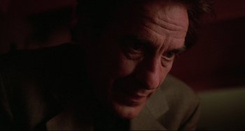 Movie still from “Love Streams” (1984), directed by John Cassavetes – A man's face in a dark room; Close Up shot, Low angle