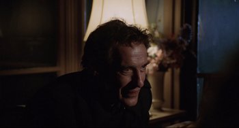 Movie still from “Love Streams” (1984), directed by John Cassavetes – A person sitting at a table; Close Up shot, Low angle