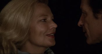 Movie still from “Love Streams” (1984), directed by John Cassavetes – A woman's face in the dark; Close Up shot, Over the shoulder angle