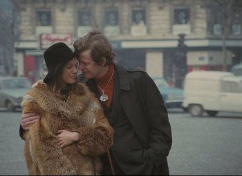 A man and a woman standing next to each other on the street