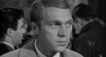 Movie still from “Love with the Proper Stranger” (1963), directed by Robert Mulligan – Black and white photograph of a man in a suit and tie; Close Up shot, Over the shoulder angle