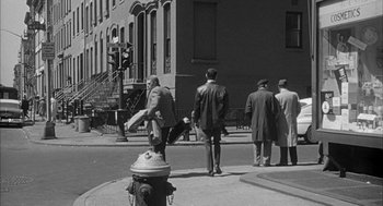 Movie still from “Love with the Proper Stranger” (1963), directed by Robert Mulligan – A black and white photo of a fire hydrant on the sidewalk; Extreme Wide shot, High angle