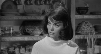 Movie still from “Love with the Proper Stranger” (1963), directed by Robert Mulligan – A black - and - white photo of a woman in a sweater; Close Up shot, Over the shoulder angle