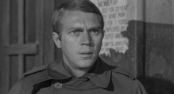 Movie still from “Love with the Proper Stranger” (1963), directed by Robert Mulligan – Black and white photograph of a man in a trench coat; Close Up shot, Over the shoulder angle
