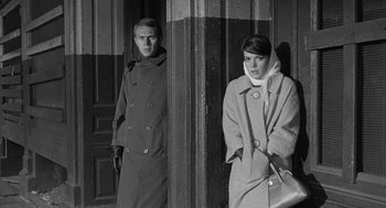 Movie still from “Love with the Proper Stranger” (1963), directed by Robert Mulligan – A man and a woman standing next to each other in front of a building; Medium shot, Low angle