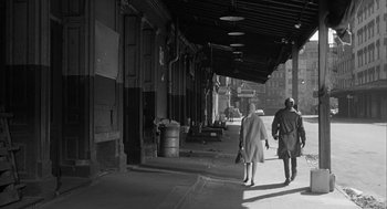 Movie still from “Love with the Proper Stranger” (1963), directed by Robert Mulligan – A man and a woman walking down a street; Wide shot, High angle