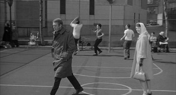 Movie still from “Love with the Proper Stranger” (1963), directed by Robert Mulligan – A group of men playing basketball on a court; Wide shot, High angle