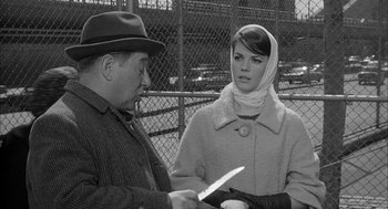 Movie still from “Love with the Proper Stranger” (1963), directed by Robert Mulligan – An older man and a young woman holding a knife; Medium shot, Over the shoulder angle