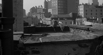 Movie still from “Love with the Proper Stranger” (1963), directed by Robert Mulligan – A couple of people standing on top of a building; Extreme Wide shot, High angle