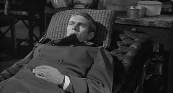 Movie still from “Love with the Proper Stranger” (1963), directed by Robert Mulligan – A black and white photo of a man laying in a chair; Medium shot, High angle