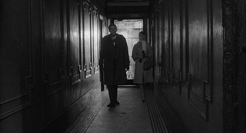Movie still from “Love with the Proper Stranger” (1963), directed by Robert Mulligan – A man and a woman walking down a hall way; Wide shot, High angle