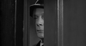 Movie still from “Love with the Proper Stranger” (1963), directed by Robert Mulligan – A black and white photo of a man wearing a hat; Close Up shot, Over the shoulder angle