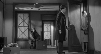 Movie still from “Love with the Proper Stranger” (1963), directed by Robert Mulligan – A black and white photo of a man and a woman; Wide shot, Low angle