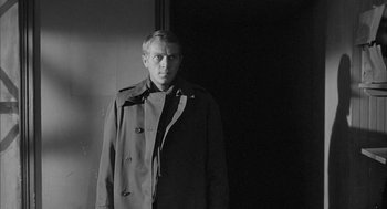 Movie still from “Love with the Proper Stranger” (1963), directed by Robert Mulligan – A black and white photo of a man wearing a trench coat; Medium shot, Low angle